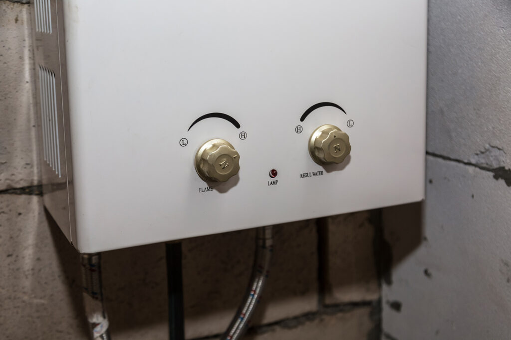 Rinnai or Navien tankless water heater installed on wall in Tomball TX home