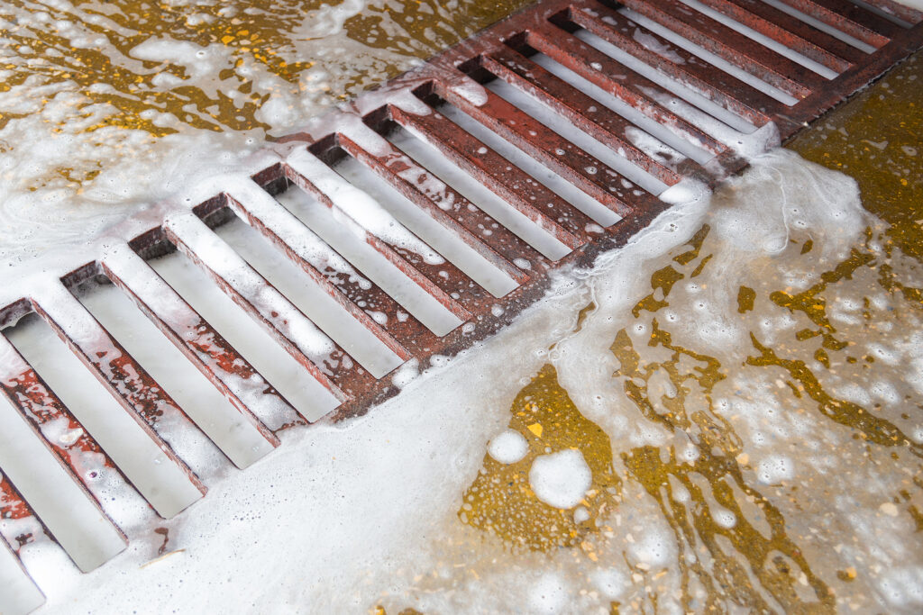 Garage floor drain backing up during heavy rain in Northwest Houston Tomball home